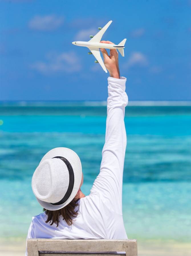 Young man with miniature of an airplane